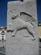 Tartini Square - Winged lion on the stone flag pole Tartini Square - Winged lion on the stone flag pole